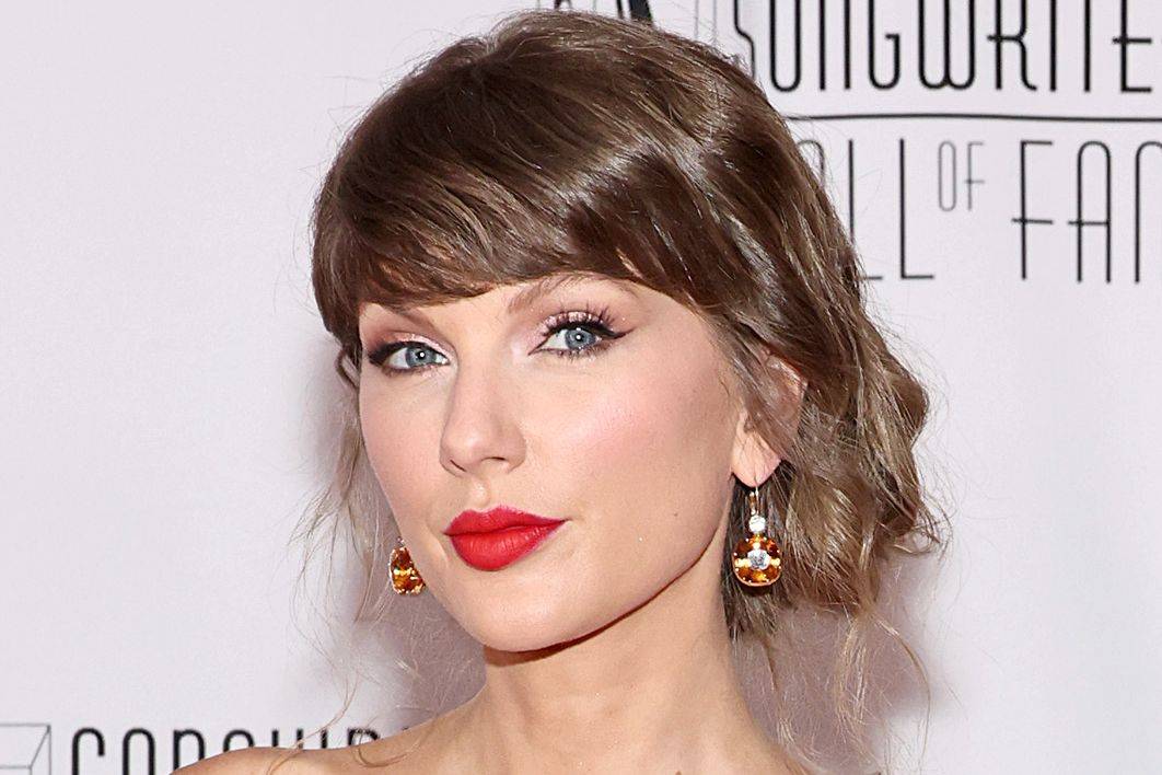 Image may contain: Taylor Swift, Clothing, Dress, Head, Person, Face, Photography, Portrait, Formal Wear, Adult, and Hair