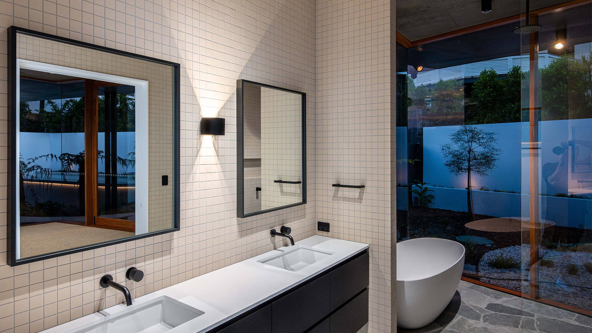 Bathroom interior shot, up & down wall light on the wall by Havit Lighting. 2 sinks with mirrors each