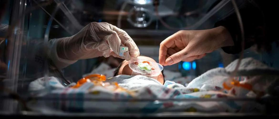 Closeup of preemie receiving lung surfactant therapy, symbolizing hope and care.