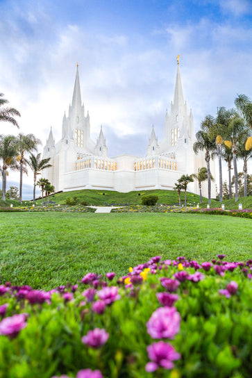 San Diego Temple standing on a hill. Purple flowers fill the forefront