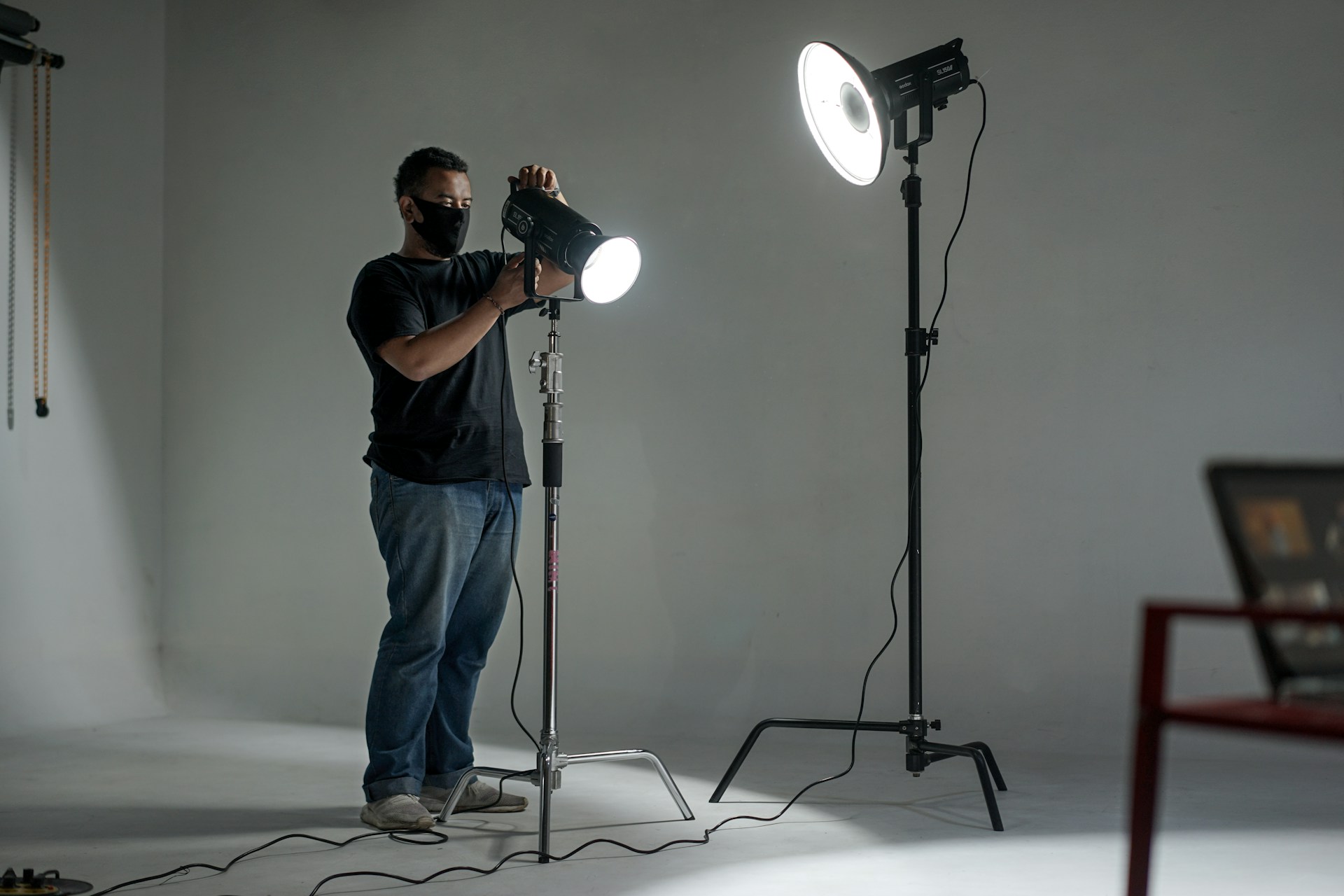 A content creator setting up studio lights on a budget