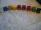 L to R clear, satin gold, gold, dark red, satin burgundy, red, green, 