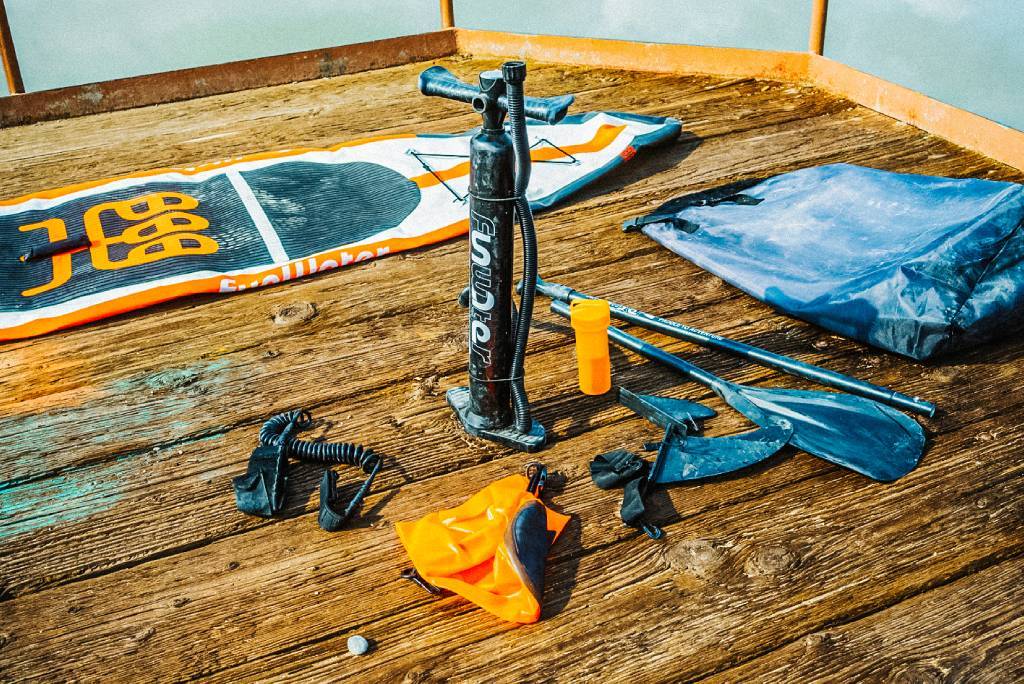 Deflate the inflatable paddle board before rolling up the blow up paddle board