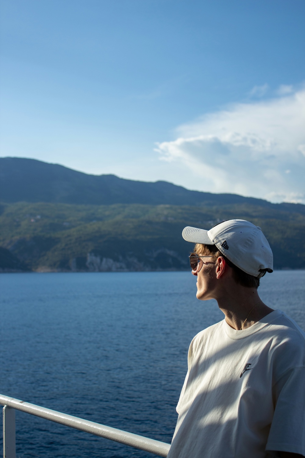 Image of a person looking out at the sea from a boat