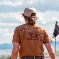 Female rancher facing opposite direction wearing American Cattle Co T-Shirt