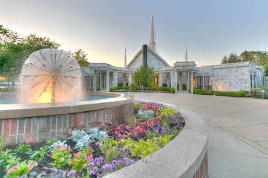 A semi-circle of pink flowers is in the forefront of the Vancouver Temple.