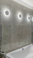 Halo LED wall lights by Havit illuminating modern bathroom feature wall