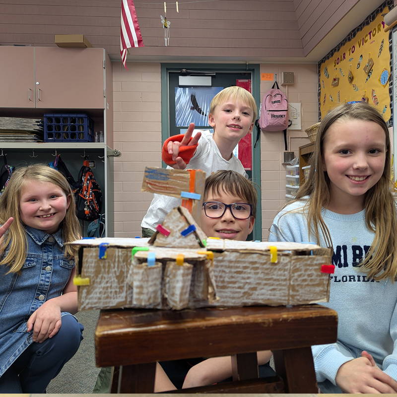students with cardboard tmodel of white house