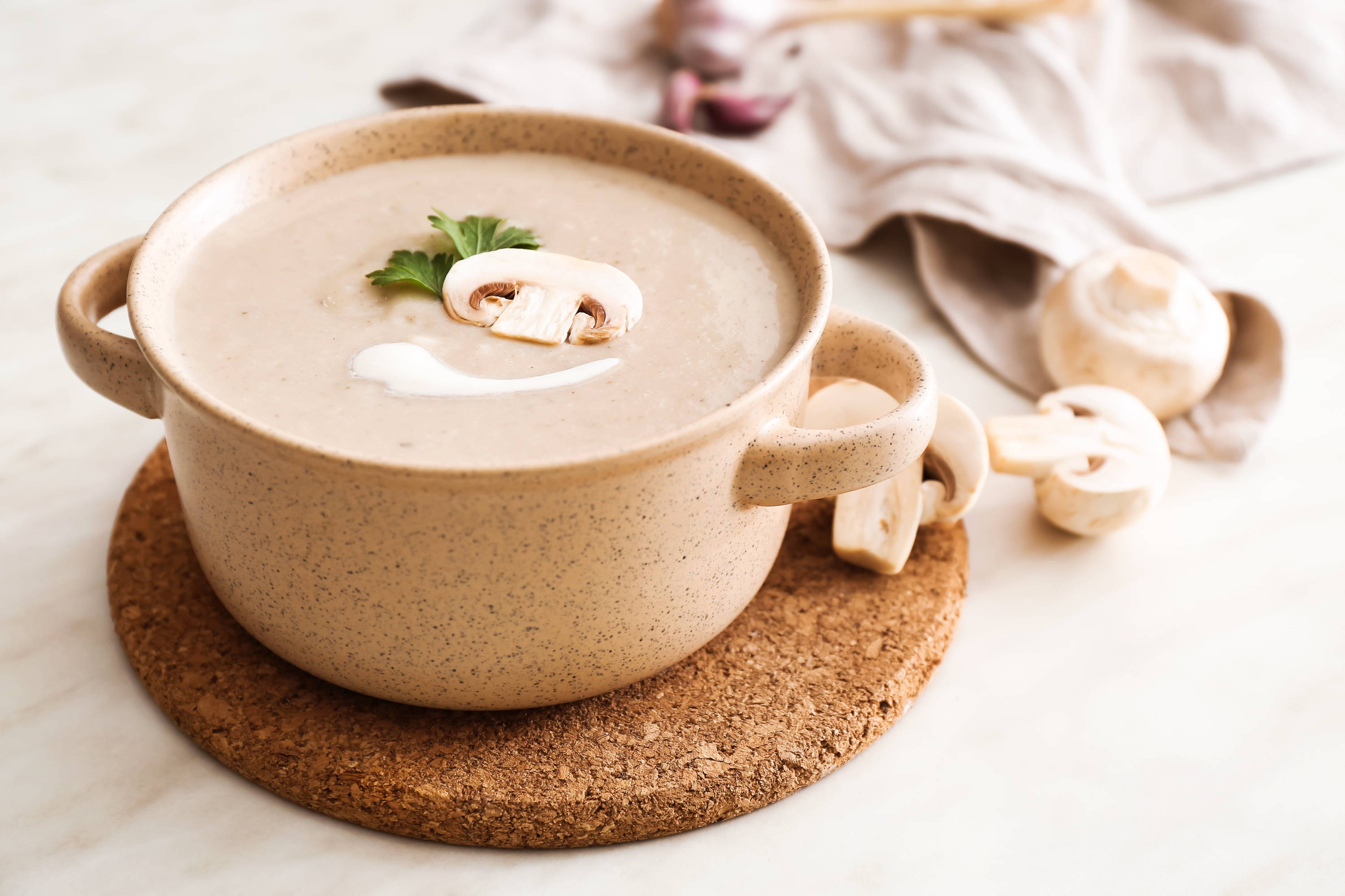 creamy mushroom soup on a wooden background  with mushrooms