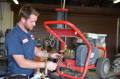 Service technician servicing/repairing pressure washer