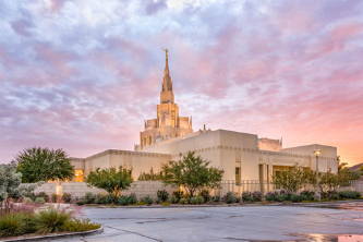 Phoenix Temple against a purple, pink, and orange sunset.