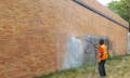 remove spray paint on blonde brick building