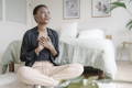 woman sitting on a floor looking happy