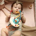 Baby biting a Montessori Silicone Pulling Toy.