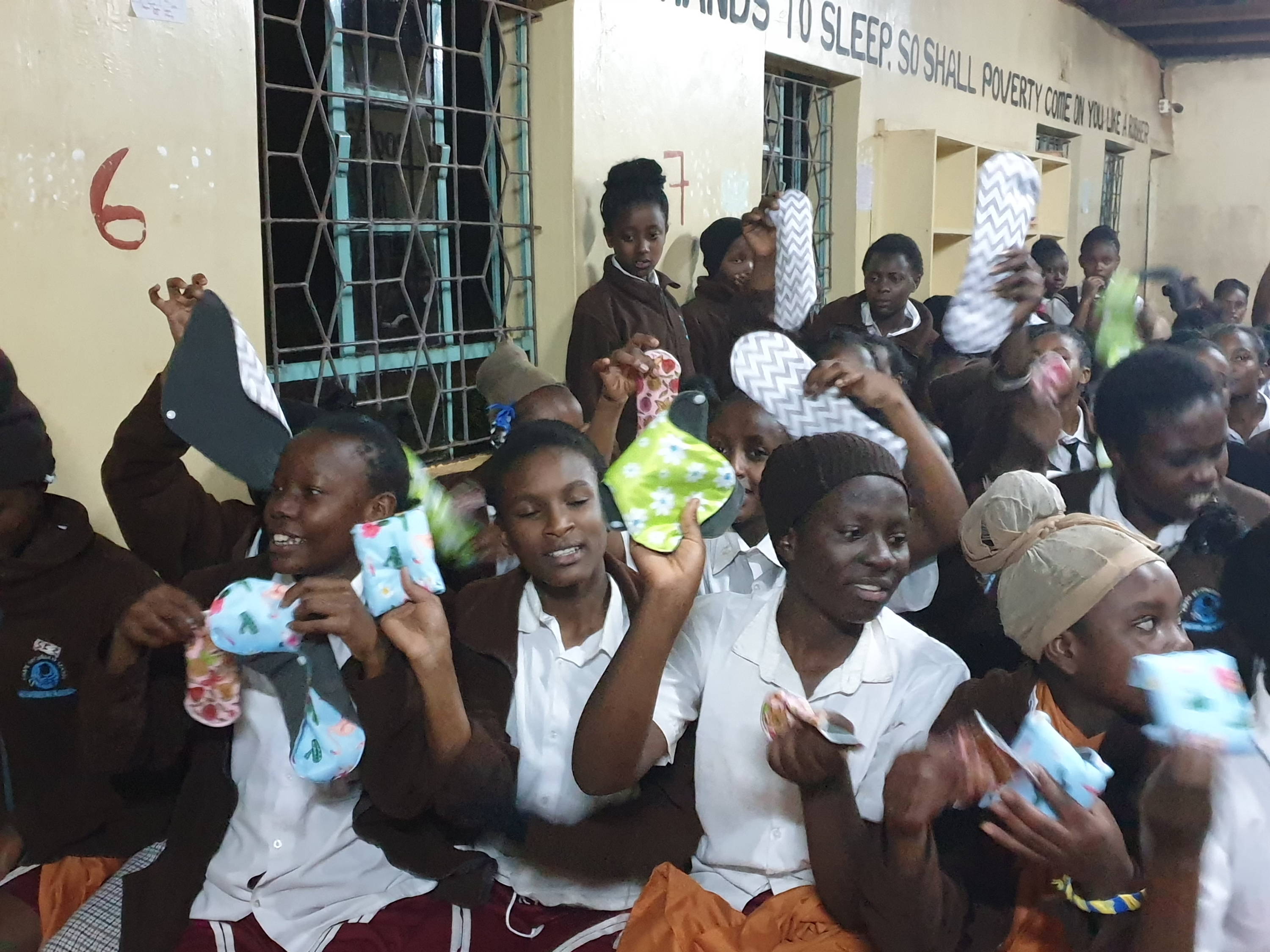 The women's shelter in Uganda receiving Flow Co.'s donation of reusable period pads to the village.