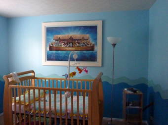 Noah's ark painting hanging above the crib of a child's nursery.