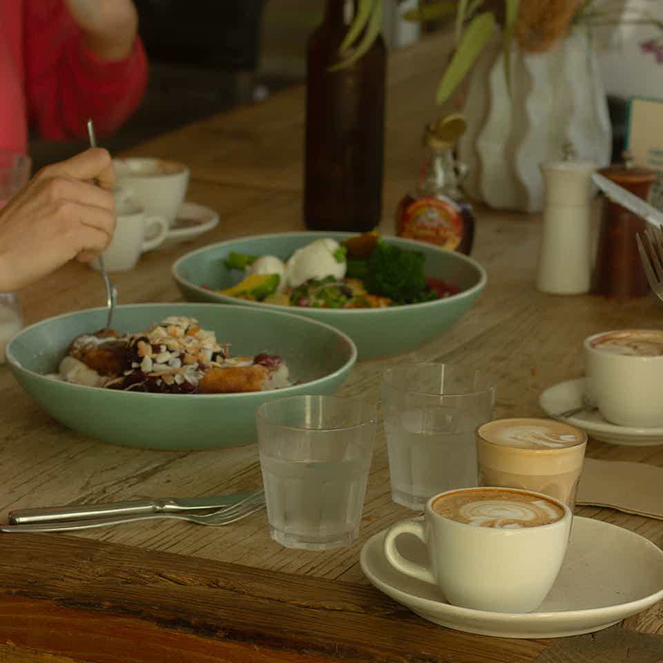 Female barista pouring coffee milk