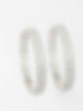 Intricately designed silver bangles with circular diamond patterns displayed on a white background.