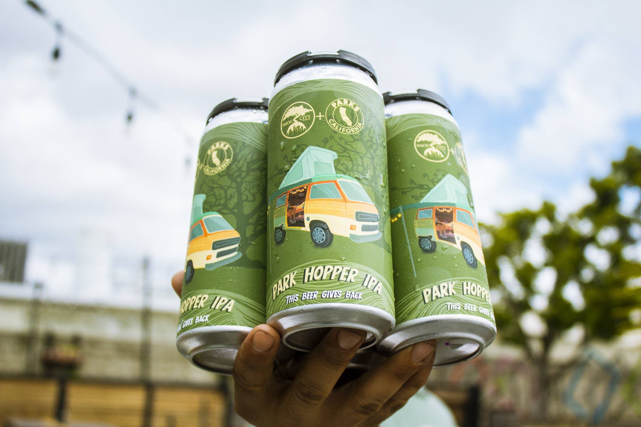 Hand Holding up a 4-pack of Park Hopper West Coast IPA