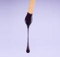 wax stick with purple wax dripping from it