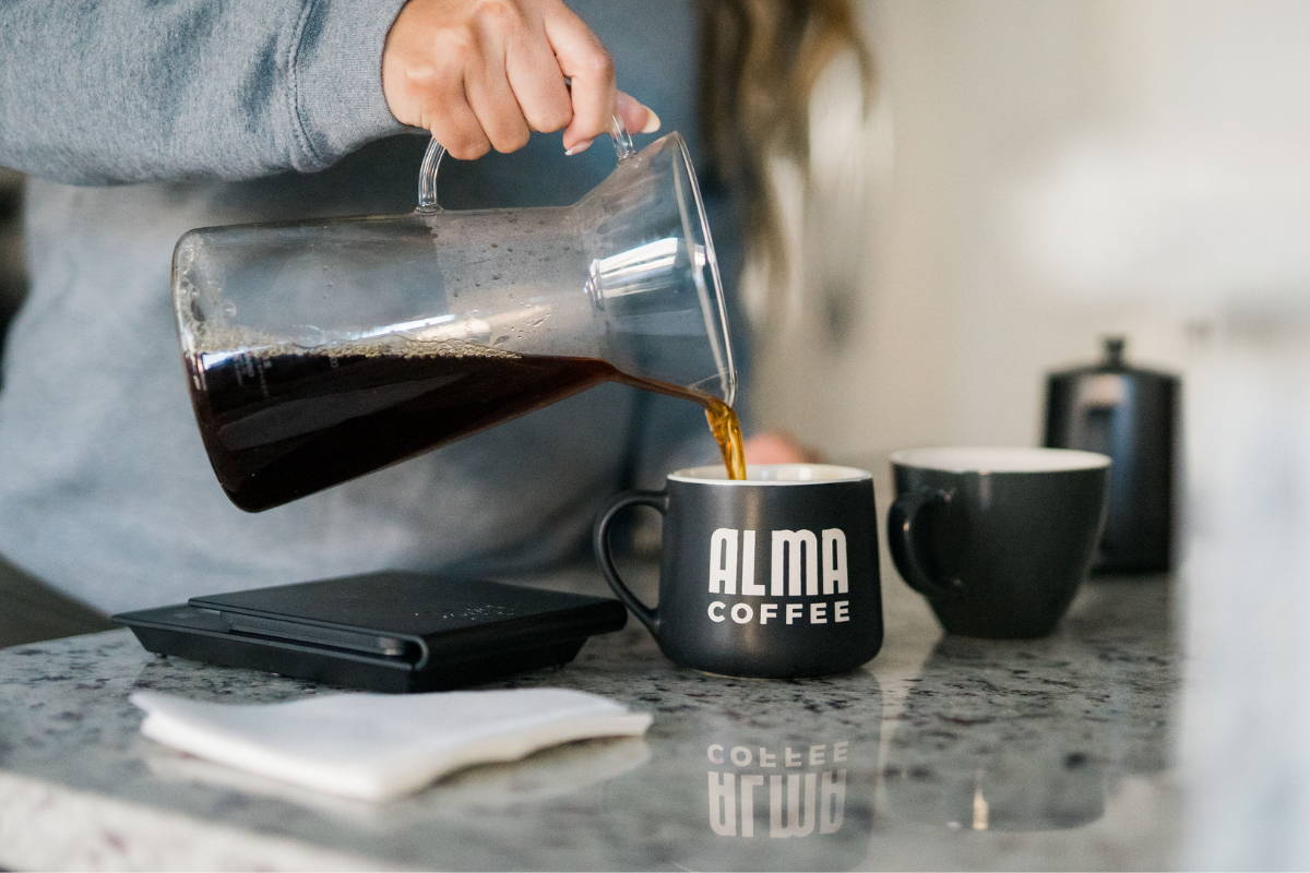 Pouring flash brewed coffee into mug