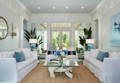 Living room with white slipcovered furniture and blue accents