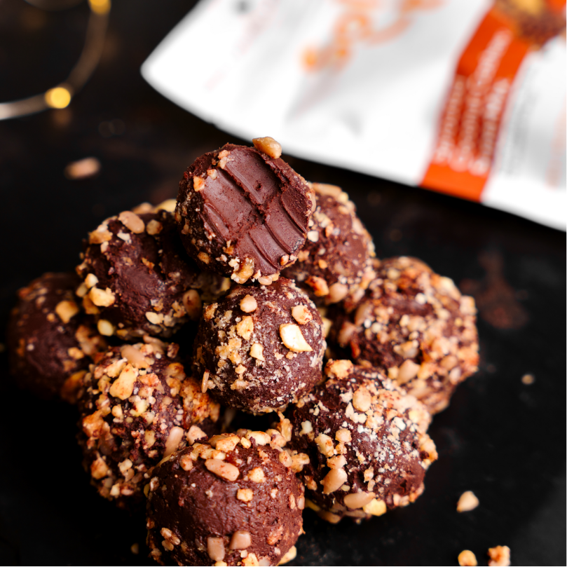 a pile of Chocolate Coconut Truffles covered on Seeds with a Bag Coconut Cashew SuperMix