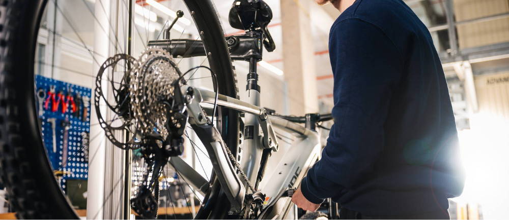 Bike mechanic servicing Cube electric bike