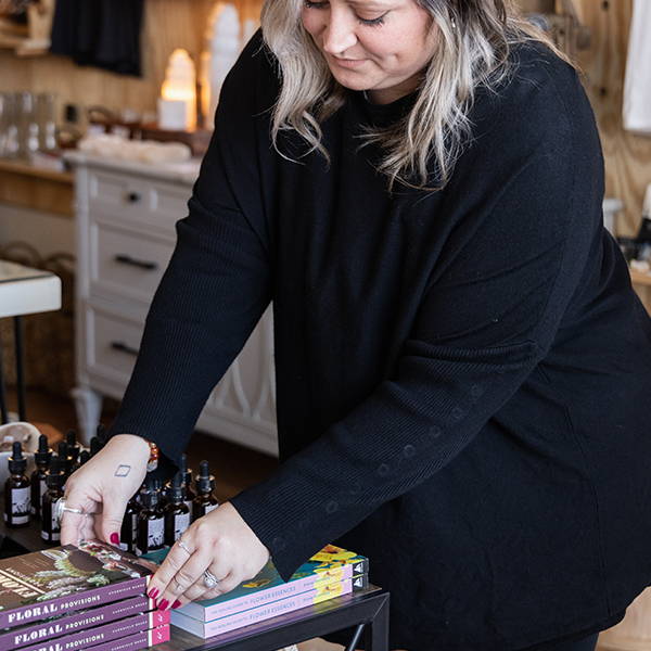 Almanac employee placing out books and tarot cards