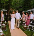 couple walking down a burlap aisle runner for an outdoor wedding ceremony