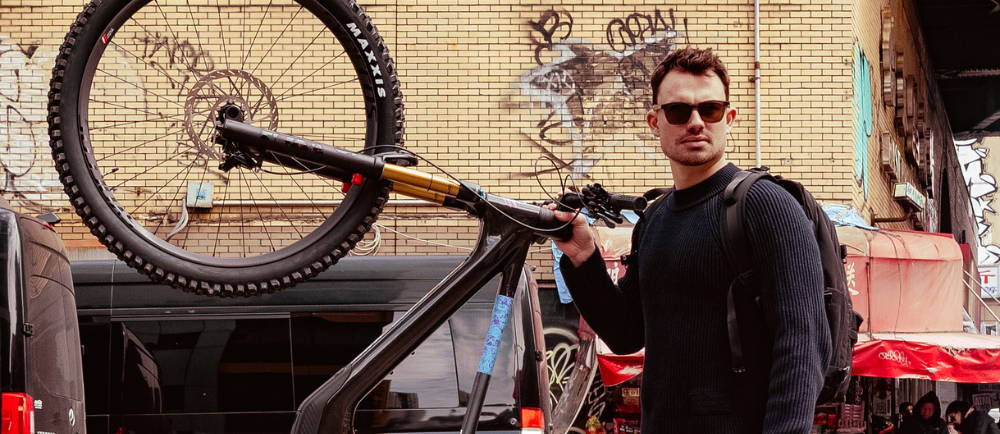 a man holding up his mountain bike