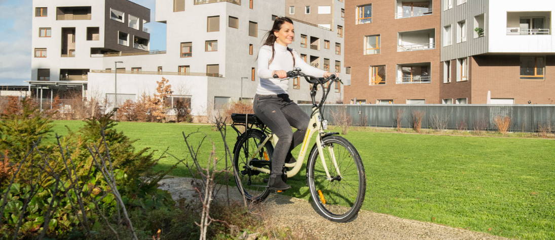 Woman riding an electric bike without pedaling.