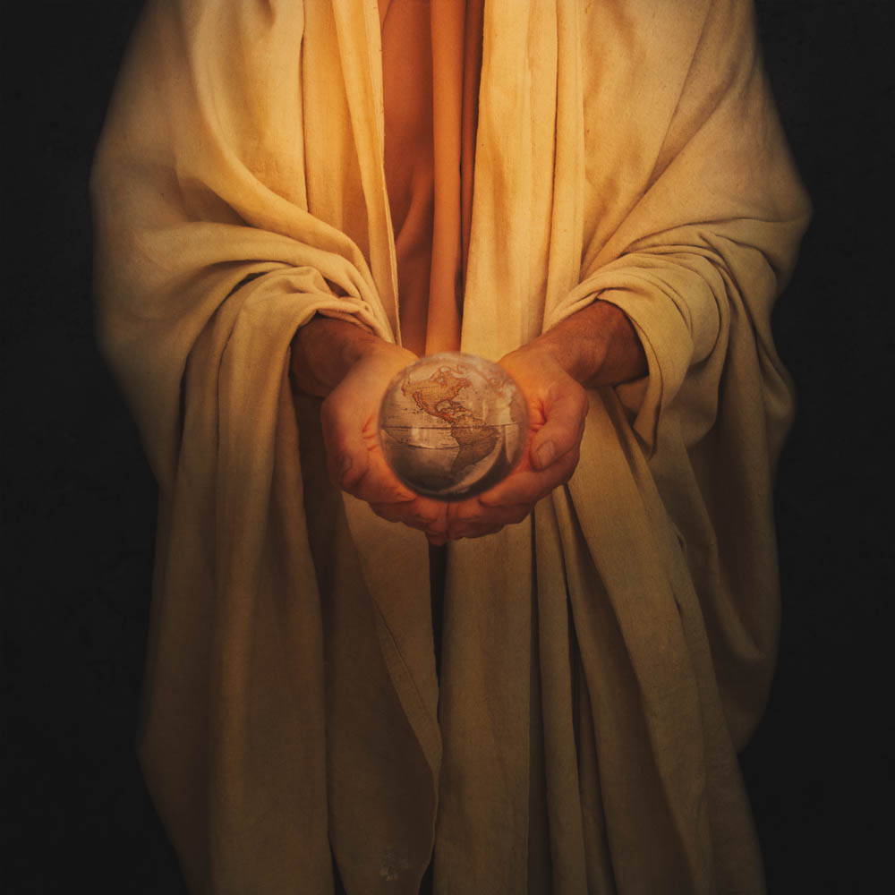 Jesus holding the Earth in His hands.