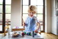 Little boy in his Montessori inspired kitchen.
