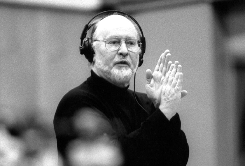 John Williams wearing headphones at a sound scoring session. 