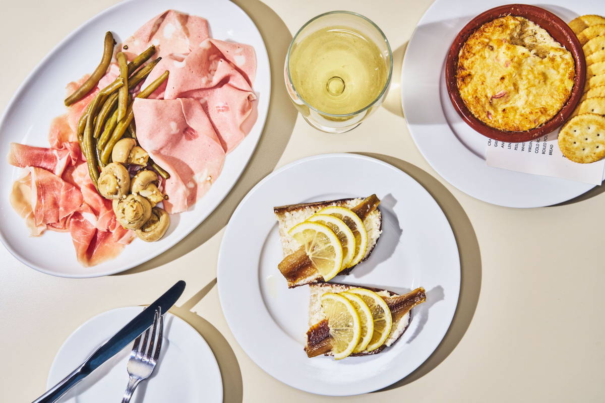 Plates of small bites with a drink