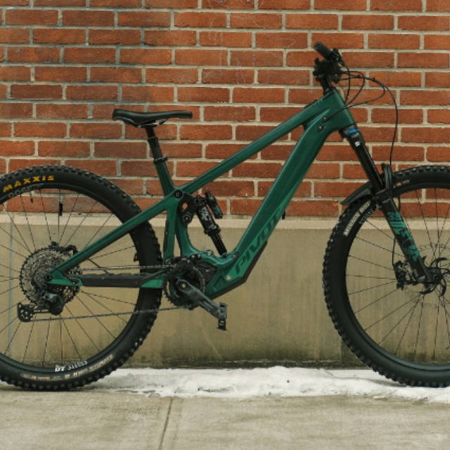 a green Pivot full suspension electric mountain bike