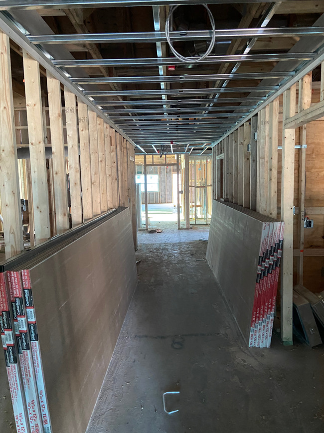 drywall in hallway of building under construction
