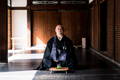 Rev. Takafumi Zenryu Kawakami sitting with a glass of tea.