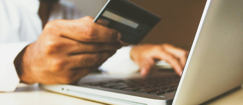 Man paying with credit card online with laptop