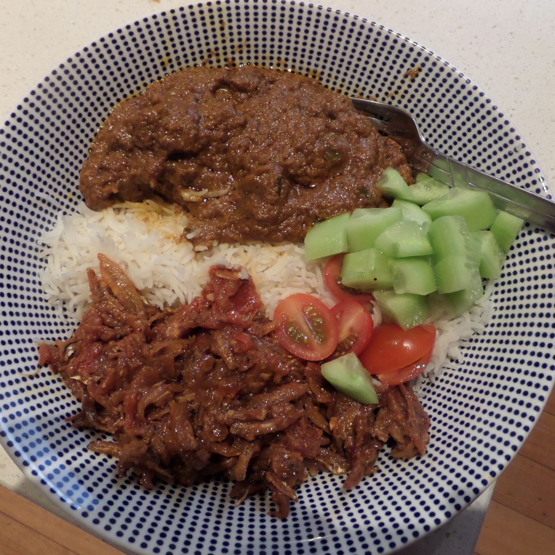 Lamb rendang with ikan bilis sambal, tomato and cucumber.