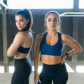 Two Latino women posing in activewear after a hiit session