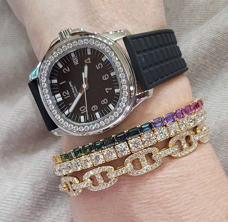 image of watch layered with bracelets