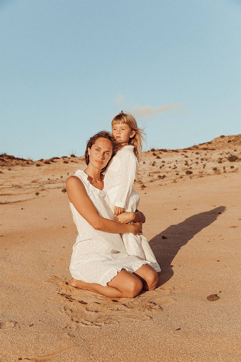 Mother and Daughter matching in cotton pyjamas on the beach