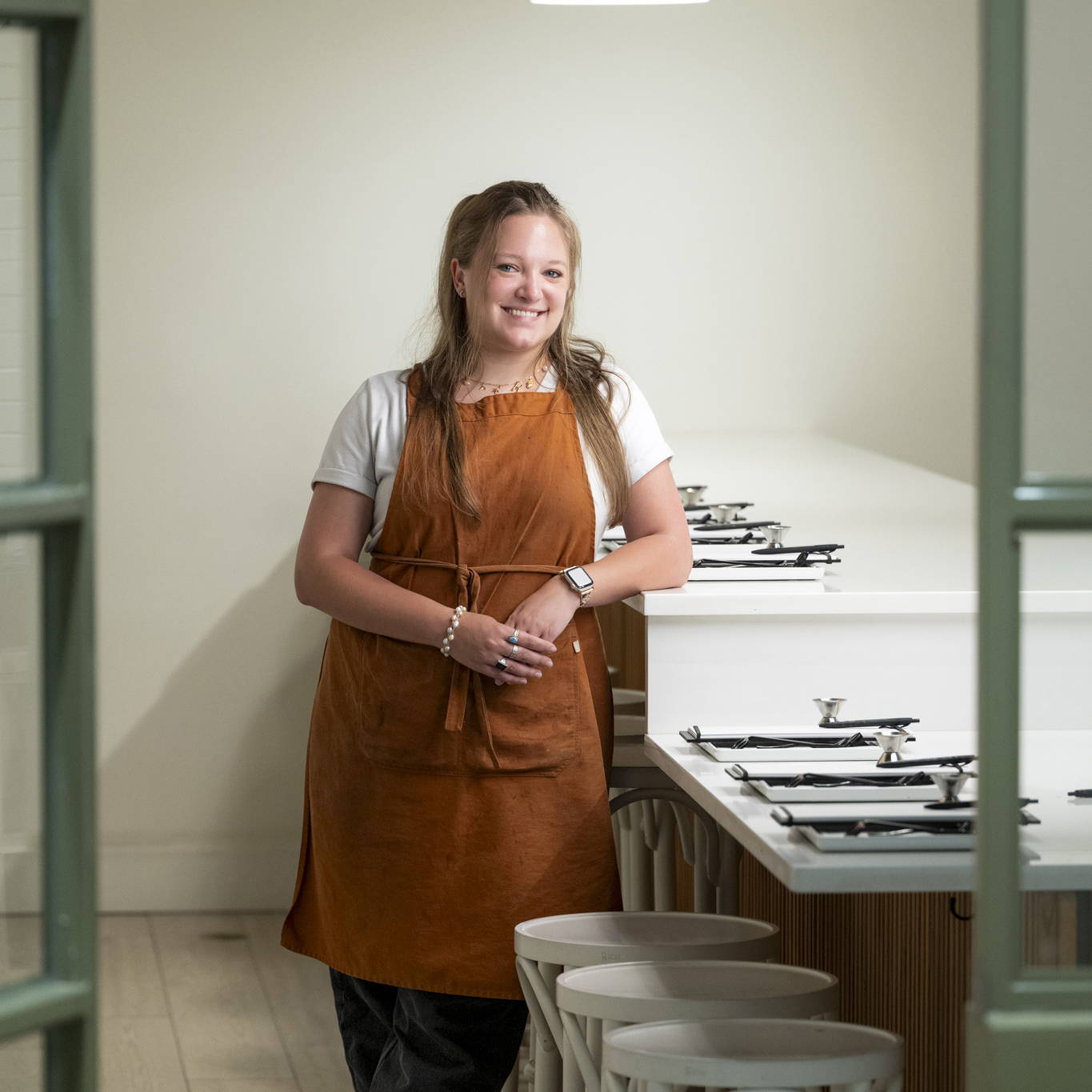 girl in orange apron smiling