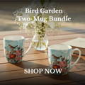Bird Garden Two-Mug Bundle on a dining table with flowers