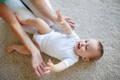 Baby playing on floor.
