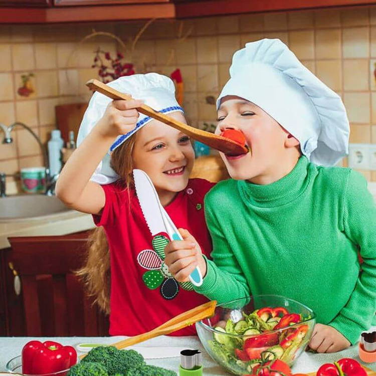 Brother and sister cooking together and eating vegetables while using their Montessori Cooking Tools set.