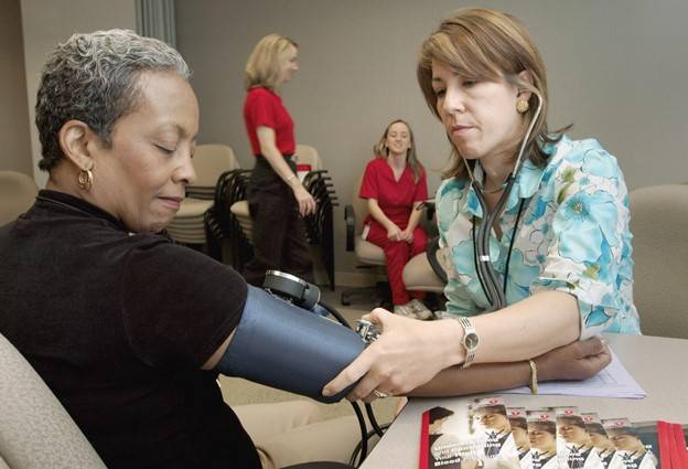 Lower your blood pressure: a woman having her blood pressure checked.