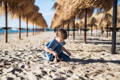 Boy digging sand on the beach.